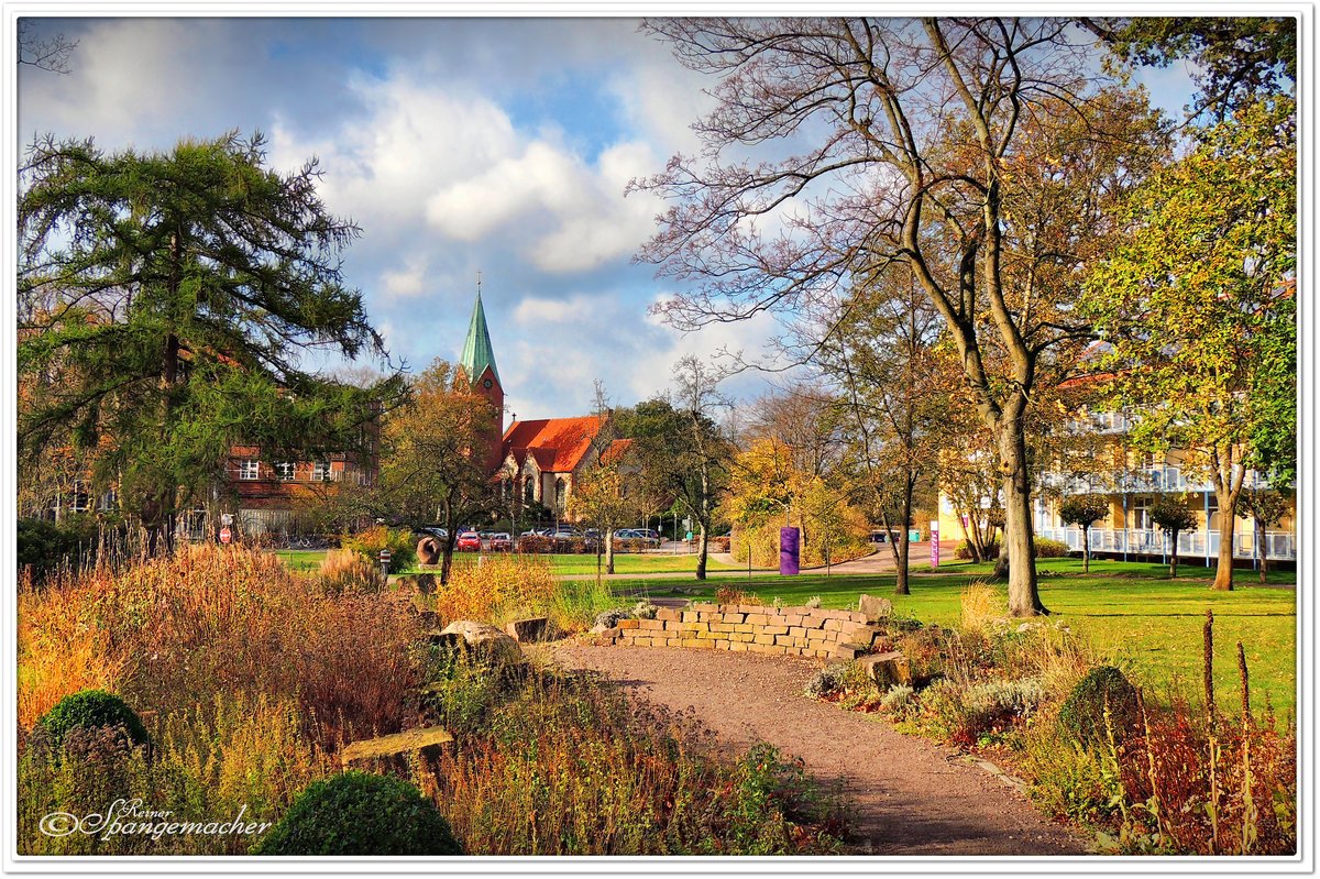Kleiner Park auf dem Altgelnde vom Diakonie Krankenhaus Rotenburg/Wmme, die Kirche im Hintergrund gehrt auch zur Diakonie. Ende Oktober 2013.