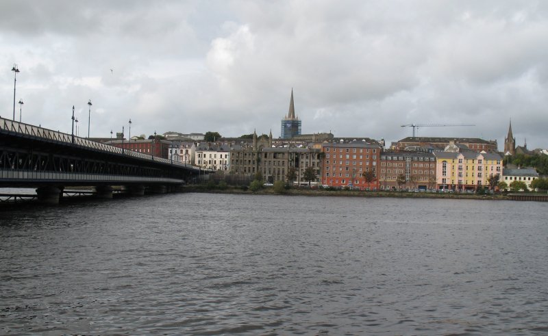 Blick ber den River Foyle auf City of Derry. So heisst Derry/Londonderry offiziell seit den 80er Jahren. Sie hat unter anderem den Spitznamen  Maiden City , also jungfruliche Stadt, da sie nie erobert wurde.
(September 2007)