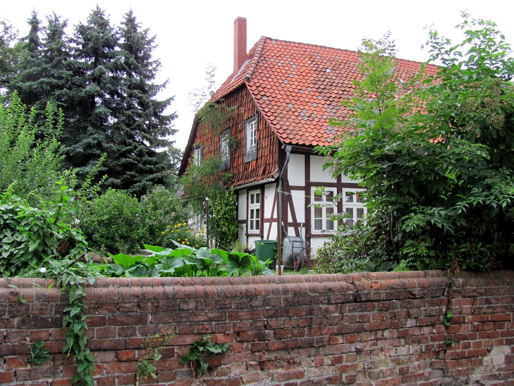 hinter alter Backstein-Mauer ein altes Bauernhaus in Edemissen