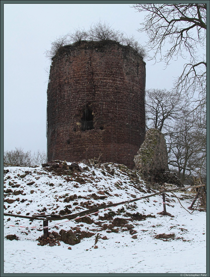 Der mächtige Bergfried der Ebersburg ist aufgrund seiner Höhe von ca. 19 m bereits von weitem sichtbar. Seine Mauern sind bis zu 4,5 m dick. Der Zugang erfolgte über den im Bild zu sehenden Einstieg mittels einer Brücke. Von der Oberburg, welche sich um den Bergfried erstreckte, ist noch einige Mauerreste erhalten geblieben, ein Teil ist im Bild sichtbar. Davor befand sich die Unterburg. Die im 12. Jahrhundert errichtete Burg verfällt seit dem 16. Jahrhundert zunehmend. Neben dem Bergfried ist auch das <a href= http://www.staedte-fotos.de/bild/bauwerke~burgen-und-schloesser~deutschland/52121/von-der-im-12-jahrhundert-errichteten.html >Kammertor</a> erhalten geblieben. Nach dem jüngsten Absturz eines Mauerstücks am Bergfried ist dieser nun mit Netzen gesichert. Ein Verein bemüht sich um die Sanierung der Burg. (bei Herrmannsacker, 24.01.2015)