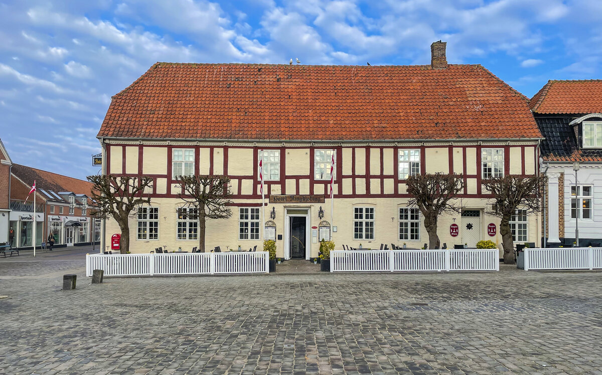 Hotel Ringkbing am Torvet (Markt). Ringkbing ist eine alte Handels- und Seestadt mit einer Geschichte, die bis in die Mitte des 1200. Jahrhunderts zurckreicht. Die Stadt hat immer noch eine intime und gemtliche Atmosphre, und im Stadtzentrum befinden sich schne alte Huser neben engen, gepflasterten Straen. Aufnahme: 25. Mrz 2022.