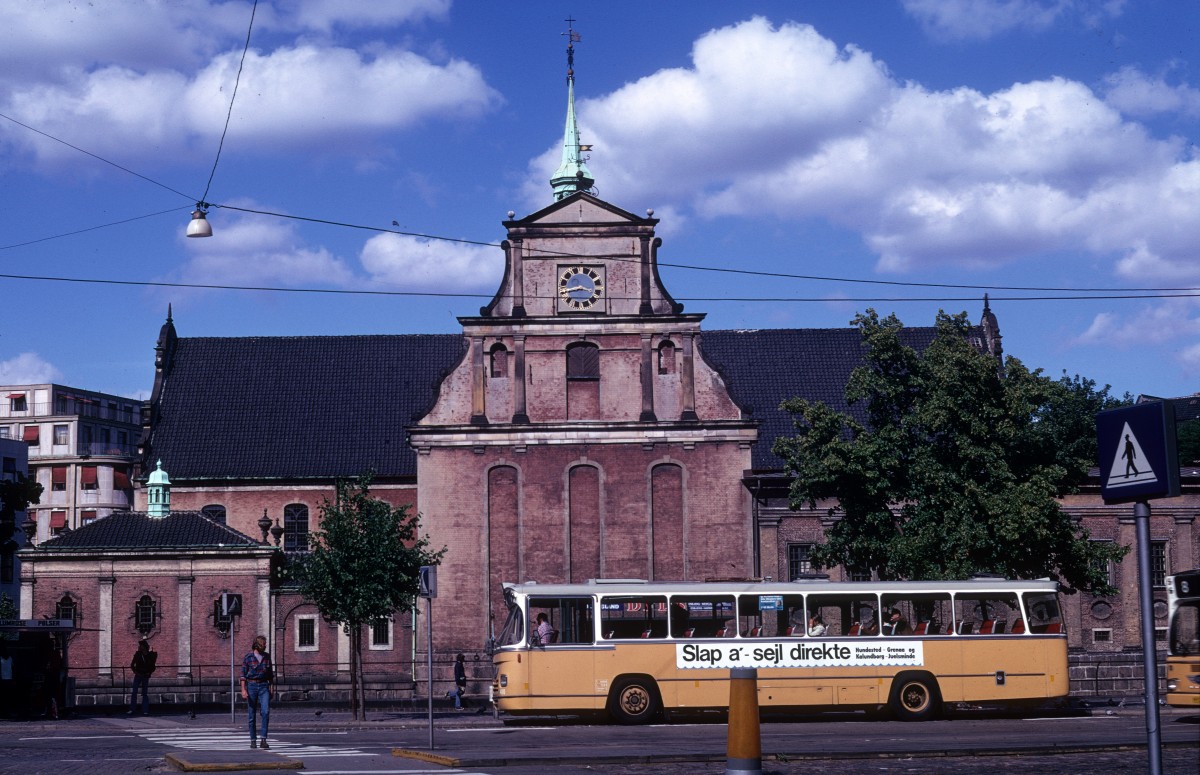 København / Kopenhagen: Holmens Kirke am 9. Juli 1973. - Ursprünglich lagen in diesem Gebiet mehr 'holme', d.h. Werder, u.a. Slotsholmen und Bremerholm. Auf dem letzten liess König Christian III eine Marinewerft erbauen, die später verlegt wurde. Der Baumeister Peter de Dunker errichte 1562-63 eine Ankerschmiede, die vom König Christian IV in eine Kirche umgebaut wurde. 1619 wurde die Kirche eingeweiht. In den folgenden Jahrhunderten wurde die Kirche erweitert und umgebaut; 1871-72 bekam die Kirche ihr heutiges Äusseres.  
