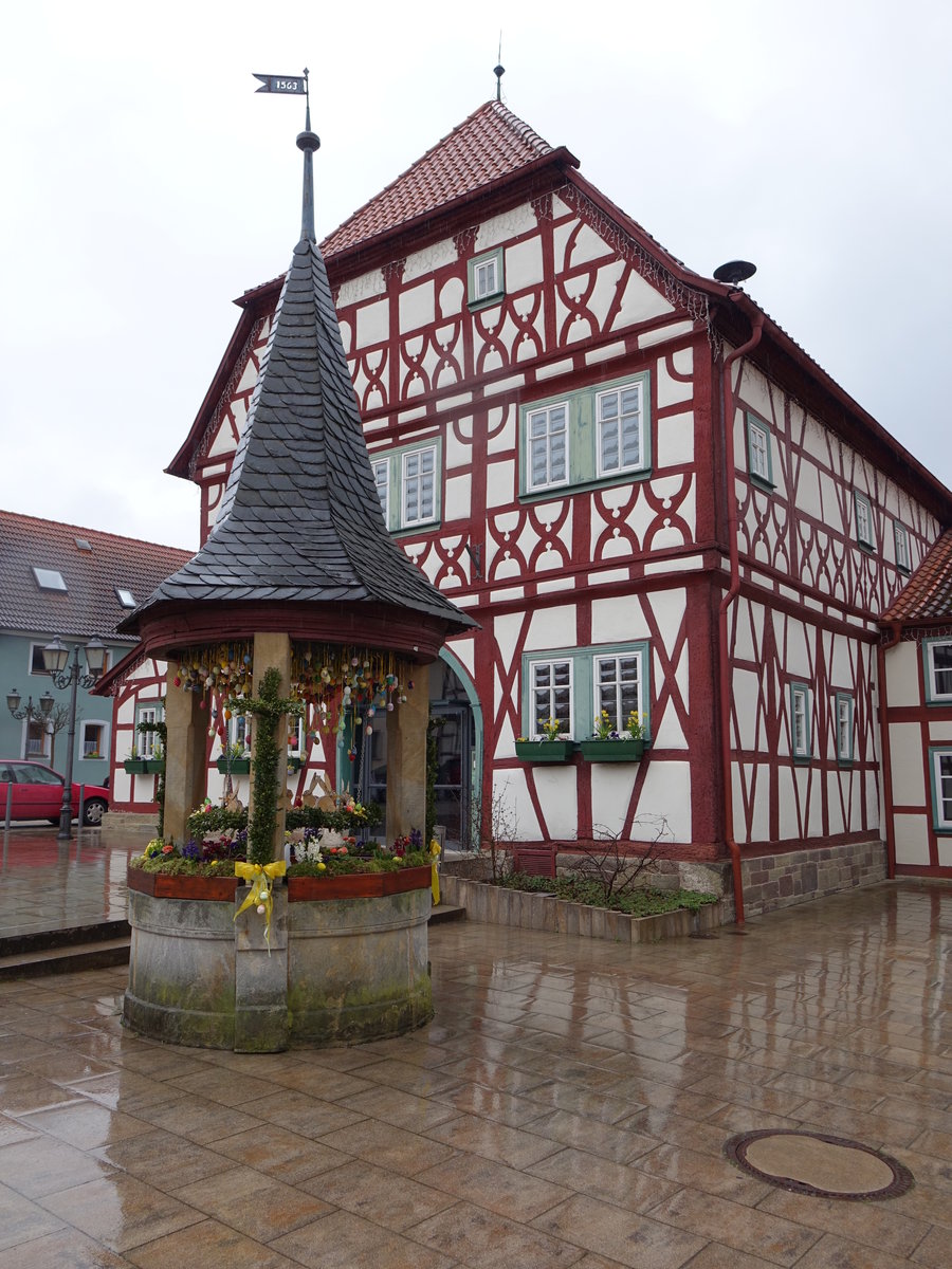 Stadtlauringen, altes Rathaus am Marktplatz, zweigeschossiger Fachwerkbau mit einseitig abgewalmten Satteldach und dreischiffiger Halle im Erdgeschoss, erbaut 1563 (25.03.2016)