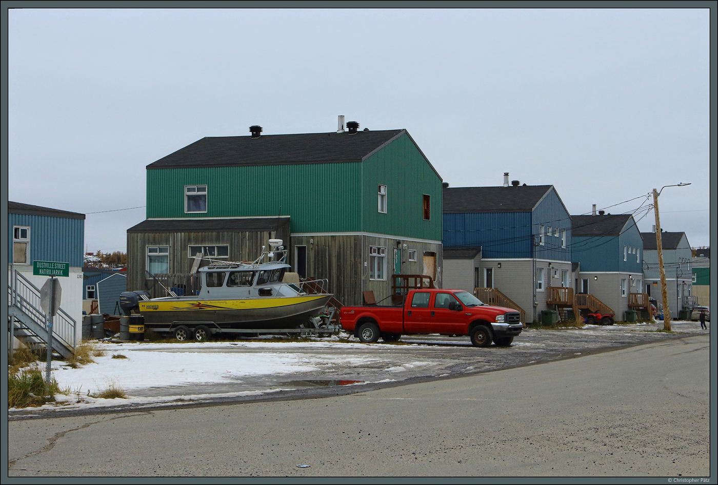 Vor einem Wohnhaus in der Dustville Street in Kuujjuaq steht ein Fischkutter. (13.10.2022)