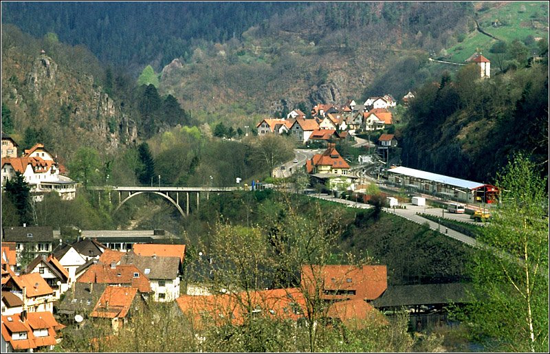 Blick ins Murgtal bei Forbach. Recht der Bildmitte der Bahnhof mit der Wagenhalle fr die Stadtbahn-Triebwagen. Die Huser hinter dem Bahnhof gehren zum Ortsteil Gausbach. Das Murgtal ist an dieser Stelle sehr eng und felsig. Interessant die Streckenfhrung der Bahn mit vielen Kunstbauten durch diese Engstelle. Scan vom Dia, 2004 (Matthias)