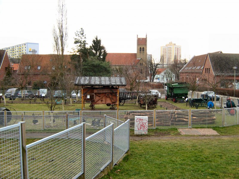 Blick ber die Sammlung alter landwirtschaftlicher Gerte auf die Kirche von Alt-Marzahn, im Hintergrund Hochhuser   17. 1. 2008