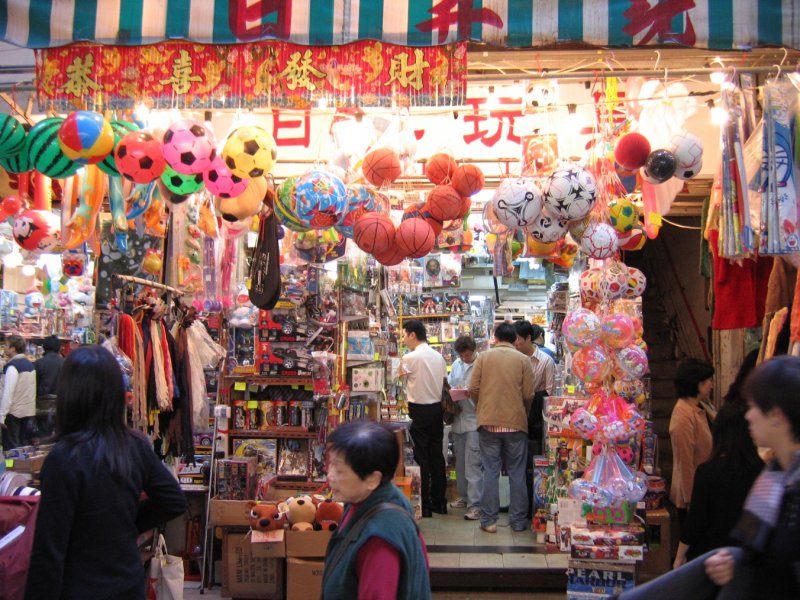 Hong Kong - Szenen auf einem Strassenmarkt zwischen Hopewell Center und Hennessy Rd. Das Auge kann sich nicht sattsehen in der bunten Vielfalt der Platikspielzeugs. Und Kinderherzen schlagen bestimmt hher, wenn sie nach einem Marktbesuch auch eine kleine berraschung aus dem Laden erhalten.