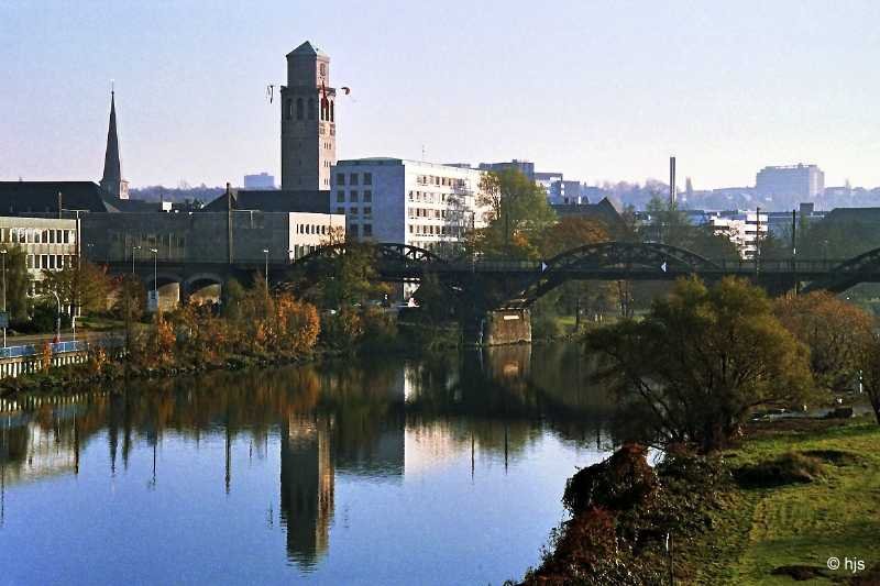 Mlheim ist die einzige Grostadt im Ruhrgebiet, deren Zentrum unmittelbar an der Ruhr liegt. Hier ein Blick aus NW. Besonders markant sticht der Rathausturm hervor. Links der Turm der Petrikirche, rechts hinten das Gebude der Max-Planck-Institute fr Kohlenforschung und fr Strahlenchemie (19. November 1989).
