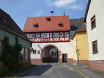 Faulbach, Rathaus, Torhaus,  zweigeschossiger Satteldachbau ber die Hauptstrae gebaut, massives verputztes Erdgeschoss mit Rundbogendurchfahrt, Zierfachwerk im Obergeschoss, erbaut 1594