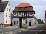 Uehlfeld, Unteres Torhaus, zweigeschossiger Fachwerkbau mit Tordurchfahrt,   Mansardwalmdach mit zwei Giebelgauben, erbaut im 18.