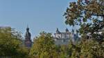 Durch die Baumwipfel im Hofgarten der Wrzburger Residenz kann man den Kirchturm der Neubaukirche sowie die Festung Marienberg ersphen.