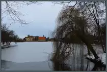 �ber zugefrorenen Schlossteich f�llt am 21.01.2024 der Blick auf die Wasserburg Flechtingen.