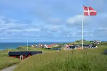 Die d�nische Flagge �Dannebrog� mit dem nordj�tl�ndischen Badeort L�nstrup im Hintergrund. Aufnahme: 13. Juni 2026.