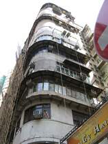 Hong Kong : Habe ich es schon erw�hnt, dass ich einen Faible f�r den klassischen Baustil aus der Kolonialzeit habe? Das muss fr�her einmal sehr modern gewesen sein. Heute liegt der Charme eher in der sch�bigen Tristesse. Aber das Bambusger�st verheisst ja, dass man an der versch�nerung arbeitet.