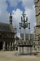 Die Ortschaft Saint-Th�gonnec im Finisth�re verf�gt �ber einen ber�hmten  Umfriedeten Pfarrbezirk  (Enclos Paroissial). Diese Pfarrbezirke stellen in der sakralen Kunst Europas ein einzigartiges Ph�nomen dar und kommt in dieser Form nur in der Bretagne vor. Ein enclos paroissial besteht aus 5 Elementen: dem Friedhof, einem Triumphtor, einem Beinhaus, dem Kalvarienberg und der Kirche. Hier der Calvaire mit der Passion Christi sowie den drei Kreuzen von Golgatha. Links dahinter das Beinhaus und am rechten Bildrand die Kirche. (23.07.2009)
