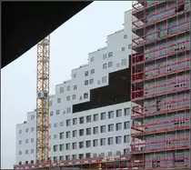 . Abgestuft - 

Das Geb�ude B der DNB Nor ist im oberen Bereich in stufenf�rmig aufgel�st. Dort befinden sich Apartments. Die helle Fassade wird durch unterschiedliche quadratischen Fenster gepr�gt. Architekten waren hier a-lab Architekter aus Oslo. Fertigstellung: 2013/14.

30.12.2013 (Matthias)