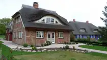 Reetdach gedeckte H�user in einer ruhigen Nebenstra�e von Middelhagen (M�nchgut, R�gen, September 2012)