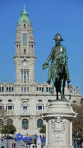 Ein Denkmal des portugiesischen Knigs Peter IV (Monumento a Dom Pedro IV), dahinter der Turm des Rathauses in Porto (Januar 2017)
